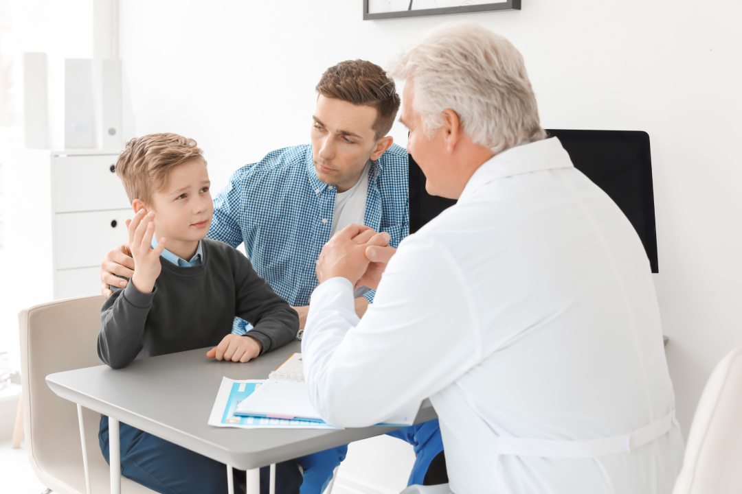 Young man with his son having appointment at child psychologist office